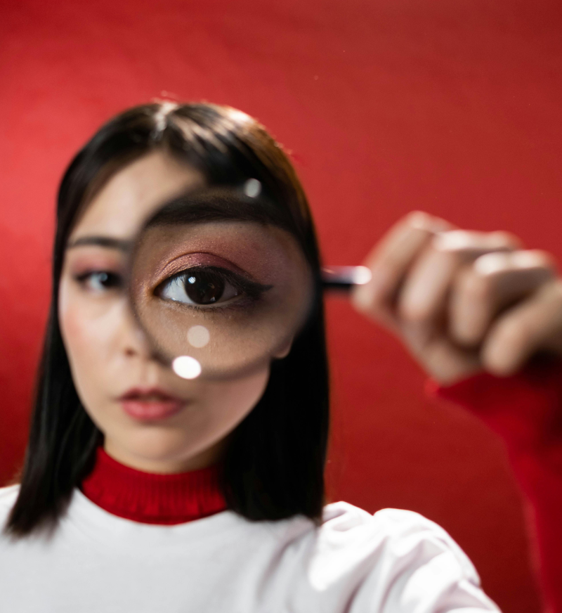 woman holding magnifying glass